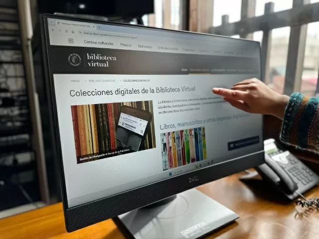 Interfaz de la biblioteca virtual con una mano señalando 