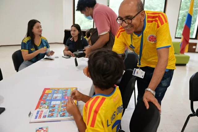 Un hombre y un niño llenando el álbum del Mundial de Fútbol 2026