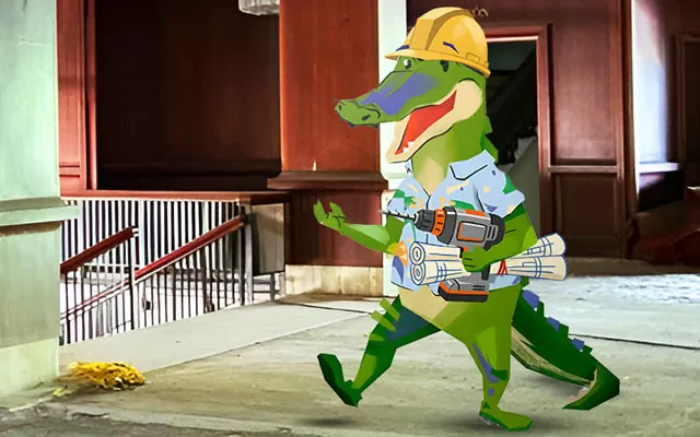 Emiro, el caimán, camina por la obra del teatro Amira dela Rosa con Planos y taladro en la mano